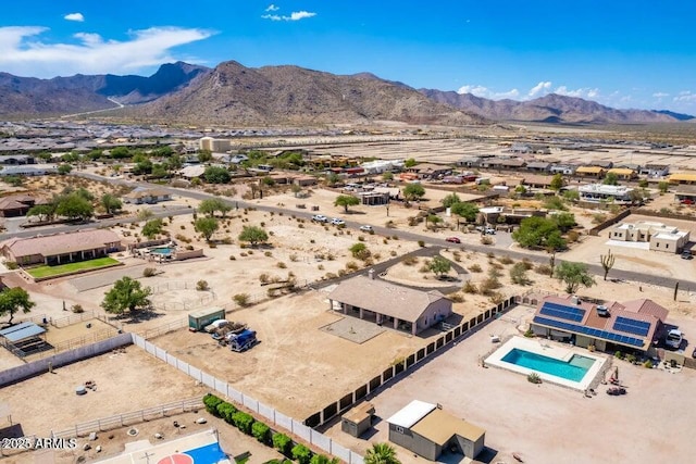 drone / aerial view with a mountain view, view of desert, and a residential view