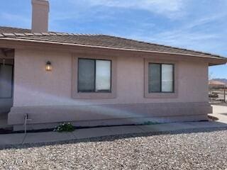view of side of home featuring stucco siding