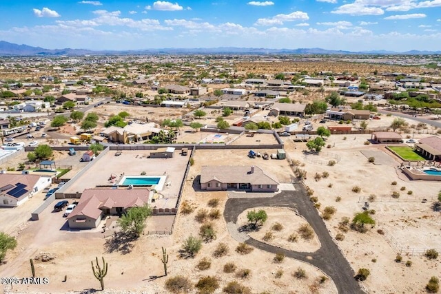birds eye view of property featuring a mountain view, view of desert, and a residential view