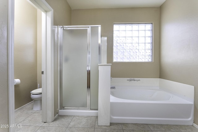 bathroom featuring tile patterned flooring, separate shower and tub, and toilet