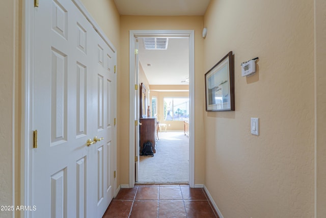 corridor with dark tile patterned floors