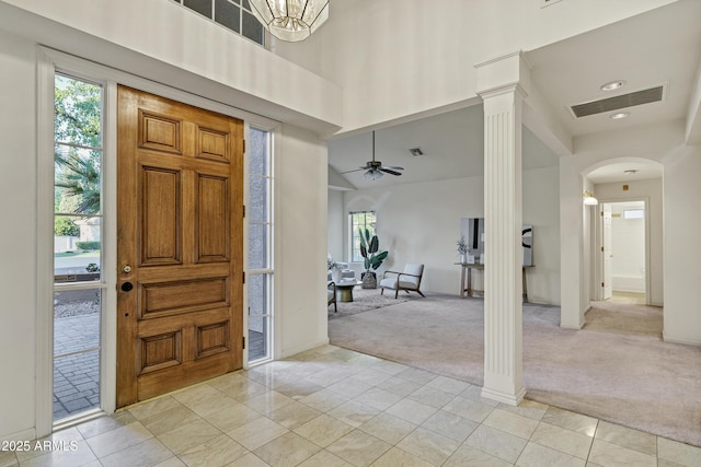 9 E Los Arboles Cir, Tempe, AZ 85284 - entryway featuring light carpet, ornate columns, a towering ceiling, arched walkways, and a ceiling fan