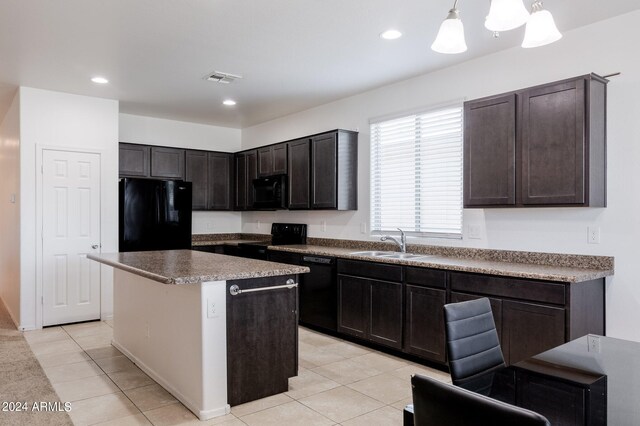 kitchen with a kitchen island, black appliances, pendant lighting, sink, and light tile floors