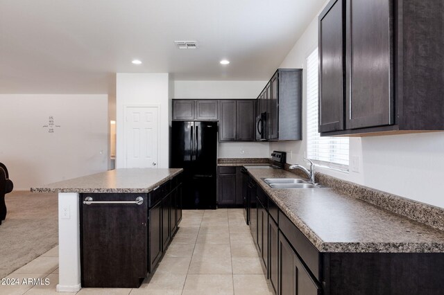 kitchen with black fridge, a center island, dark brown cabinets, light colored carpet, and sink