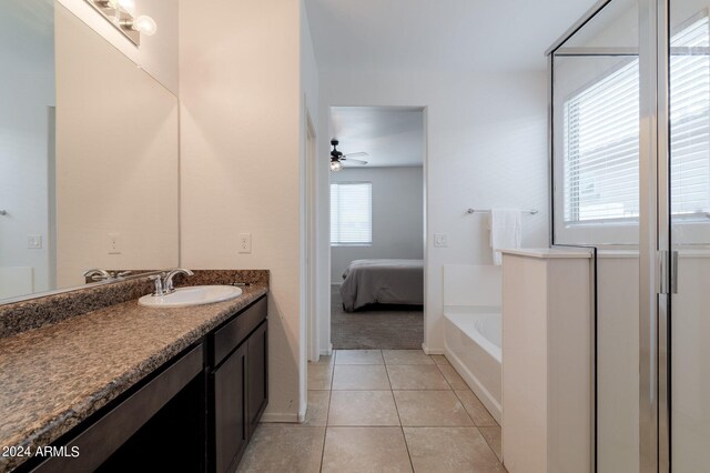 bathroom featuring a washtub, vanity, ceiling fan, and tile flooring