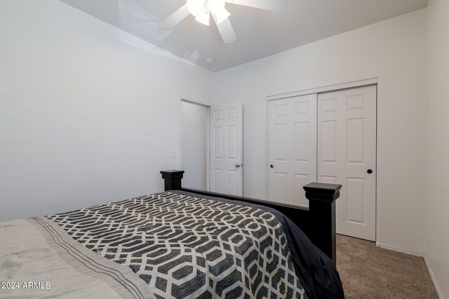 carpeted bedroom with a closet and ceiling fan