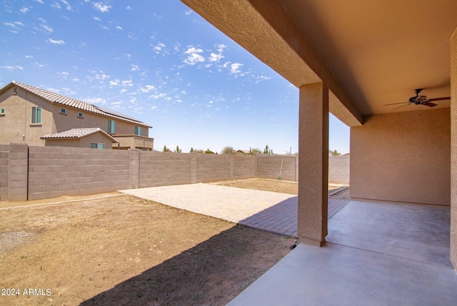 view of yard with a patio area and ceiling fan