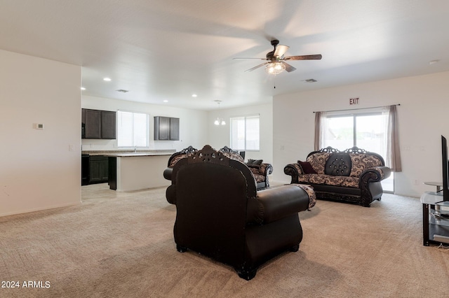 living room featuring light carpet and ceiling fan