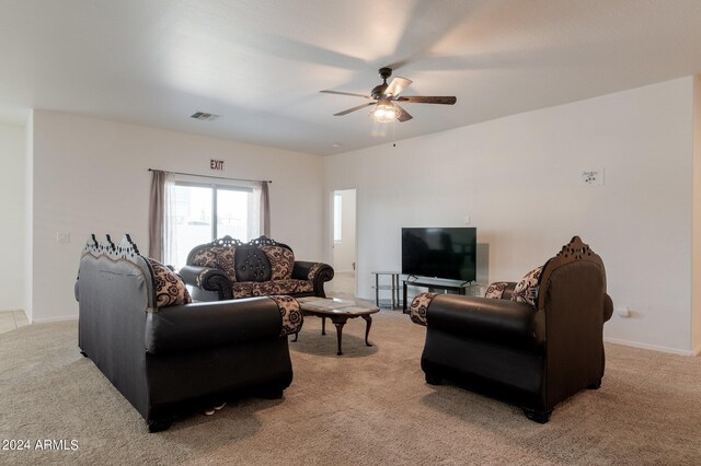 carpeted living room with ceiling fan