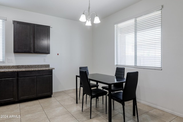 dining area featuring an inviting chandelier and light tile floors