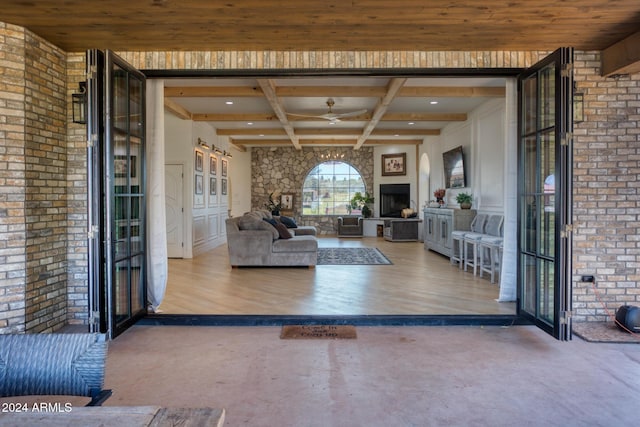 830 E Maverick, Taylor, AZ 85939 - unfurnished living room featuring hardwood / wood-style floors, beamed ceiling, brick wall, and coffered ceiling