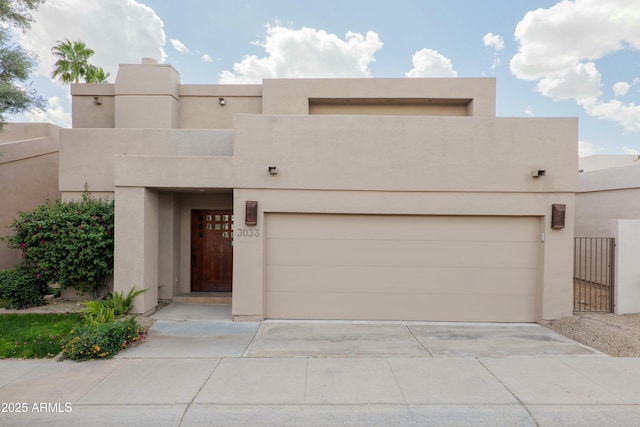 3033 E Claremont Ave, Phoenix, AZ 85016 - pueblo-style home with driveway, a garage, and stucco siding