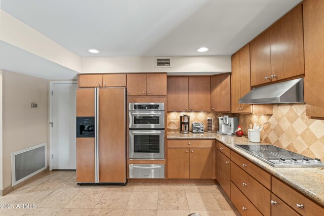 3033 E Claremont Ave, Phoenix, AZ 85016 - kitchen featuring paneled refrigerator, visible vents, electric cooktop, under cabinet range hood, and stainless steel double oven
