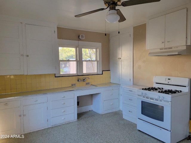 11 Black Knob Vw, Bisbee, AZ 85603 - kitchen featuring white range with gas cooktop, under cabinet range hood, light countertops, white cabinetry, and ceiling fan