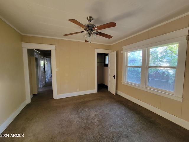 11 Black Knob Vw, Bisbee, AZ 85603 - unfurnished bedroom featuring crown molding, dark colored carpet, baseboards, a closet, and a ceiling fan