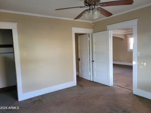 11 Black Knob Vw, Bisbee, AZ 85603 - unfurnished bedroom with carpet floors, crown molding, baseboards, arched walkways, and a ceiling fan