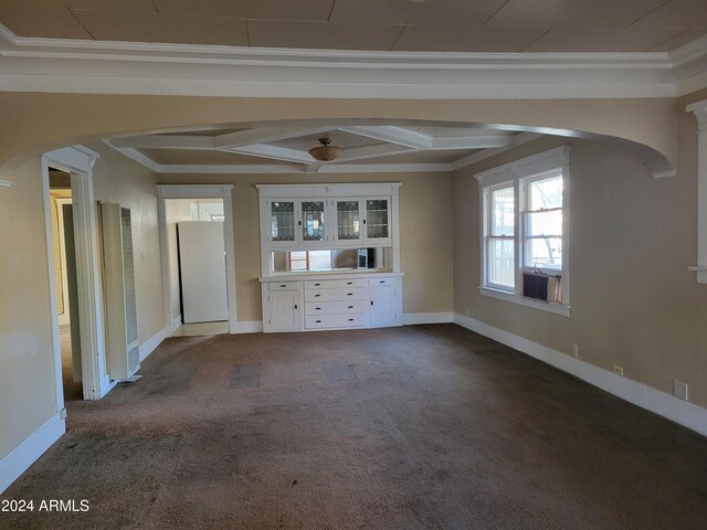 11 Black Knob Vw, Bisbee, AZ 85603 - unfurnished living room with arched walkways, dark carpet, crown molding, baseboards, and decorative columns
