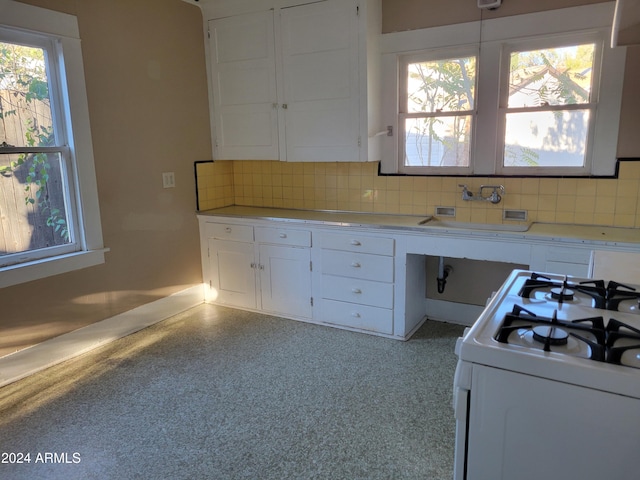 11 Black Knob Vw, Bisbee, AZ 85603 - kitchen featuring white gas stove, white cabinets, backsplash, and a sink
