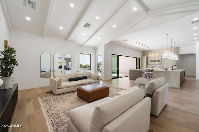 10541 E Windrose Dr, Scottsdale, AZ 85259 - living area with light wood finished floors, visible vents, beam ceiling, and recessed lighting