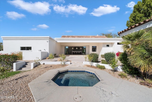 10541 E Windrose Dr, Scottsdale, AZ 85259 - rear view of house with an in ground hot tub and stucco siding