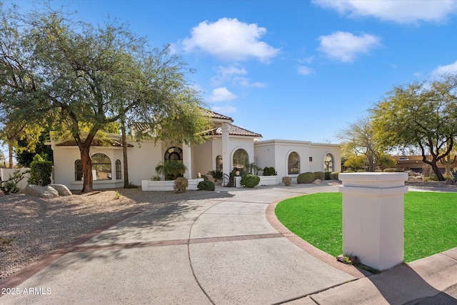 10541 E Windrose Dr, Scottsdale, AZ 85259 - mediterranean / spanish house with a tile roof, driveway, a front lawn, and stucco siding