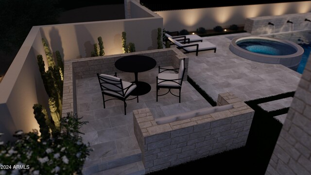 view of patio / terrace with an in ground hot tub