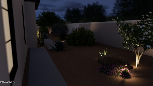 yard at night featuring a patio