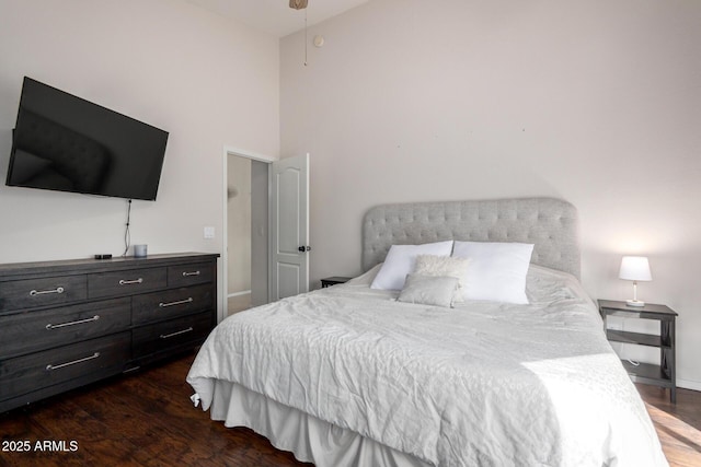 bedroom featuring baseboards and wood finished floors