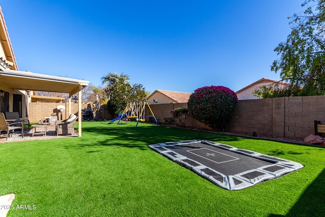 view of yard with a fenced backyard, a playground, and a patio