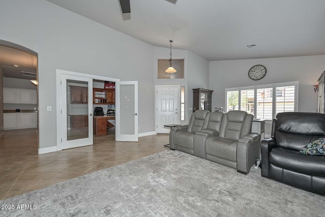 1623 E Runion Dr, Phoenix, AZ 85024 - living area with french doors, arched walkways, high vaulted ceiling, ceiling fan, and baseboards