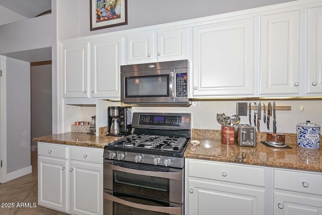 1623 E Runion Dr, Phoenix, AZ 85024 - kitchen with appliances with stainless steel finishes, white cabinetry, dark stone countertops, and tile patterned floors