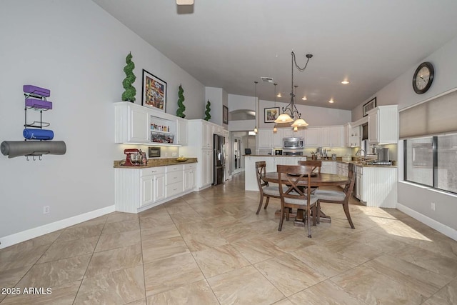1623 E Runion Dr, Phoenix, AZ 85024 - dining area featuring lofted ceiling and baseboards