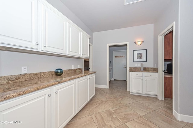 1623 E Runion Dr, Phoenix, AZ 85024 - kitchen with white cabinets, baseboards, light marble finish flooring, and light stone countertops