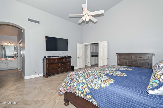 1623 E Runion Dr, Phoenix, AZ 85024 - bedroom with arched walkways, high vaulted ceiling, baseboards, connected bathroom, and a closet