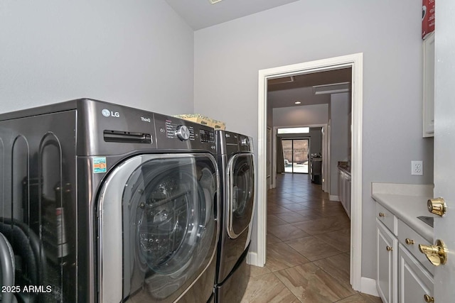 1623 E Runion Dr, Phoenix, AZ 85024 - washroom featuring washing machine and dryer, cabinet space, light tile patterned floors, and baseboards