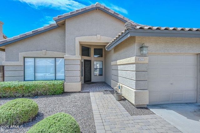 1623 E Runion Dr, Phoenix, AZ 85024 - property entrance with a garage, stucco siding, and a tile roof