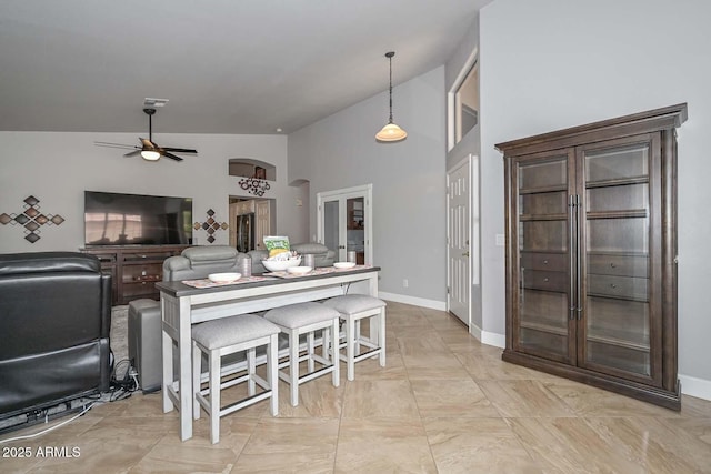1623 E Runion Dr, Phoenix, AZ 85024 - kitchen with a ceiling fan, decorative light fixtures, arched walkways, baseboards, and high vaulted ceiling