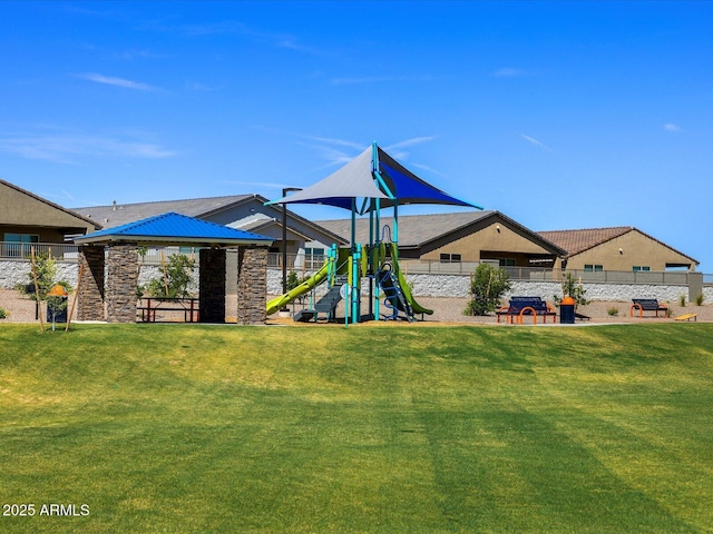 community play area with a yard and fence