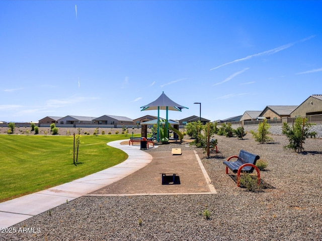 community playground with a yard, fence, and a residential view