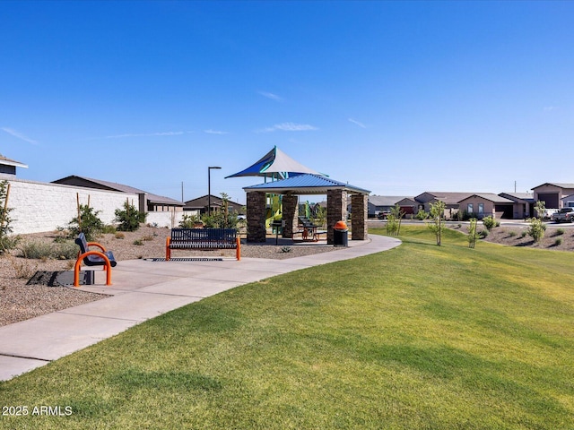 surrounding community with a lawn, a residential view, fence, and playground community