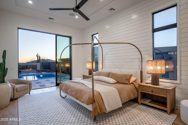 bedroom featuring recessed lighting, wood finished floors, visible vents, and access to exterior