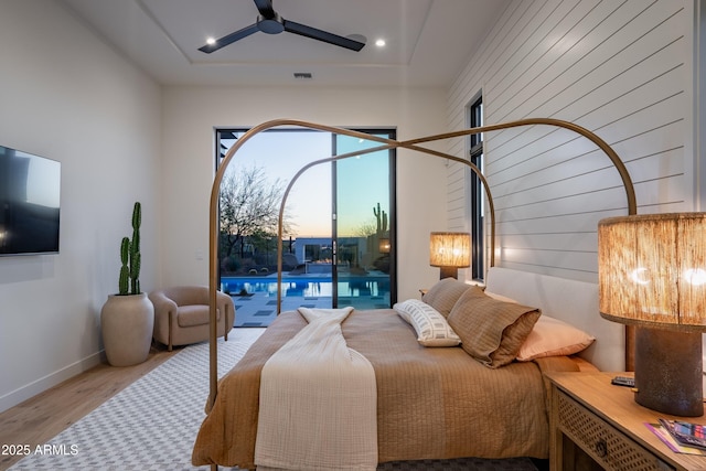 bedroom with recessed lighting, visible vents, wood finished floors, access to outside, and baseboards