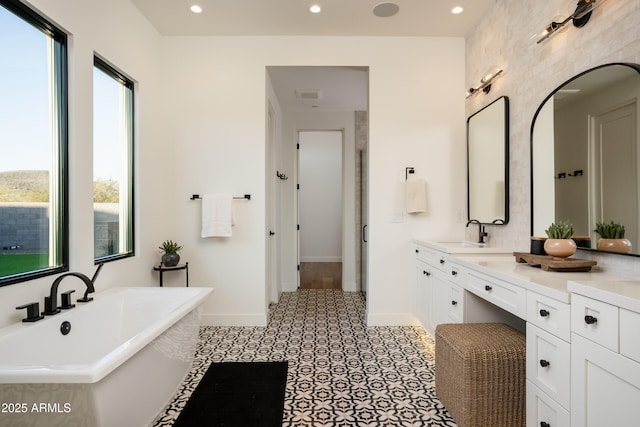 full bath with recessed lighting, a soaking tub, visible vents, vanity, and baseboards