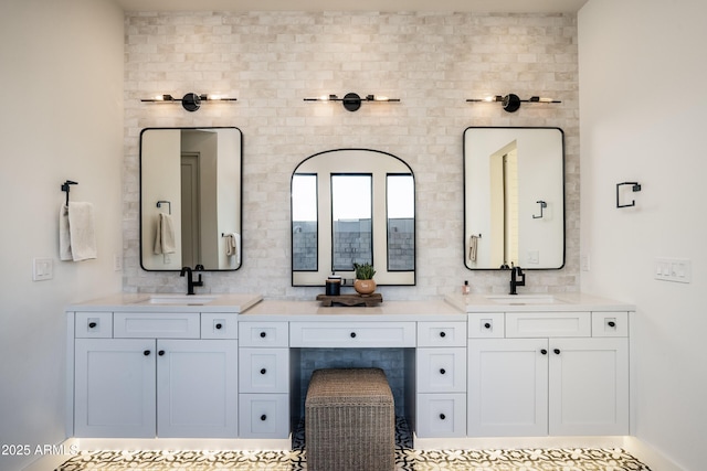 bathroom with double vanity, backsplash, and a sink