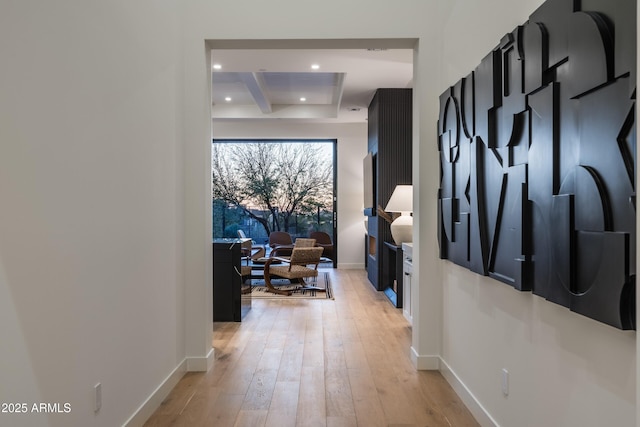 corridor featuring recessed lighting, beam ceiling, baseboards, and light wood finished floors