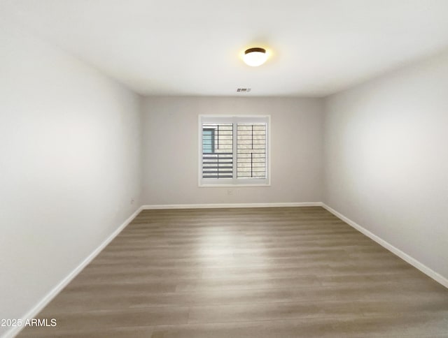 spare room with hardwood / wood-style floors