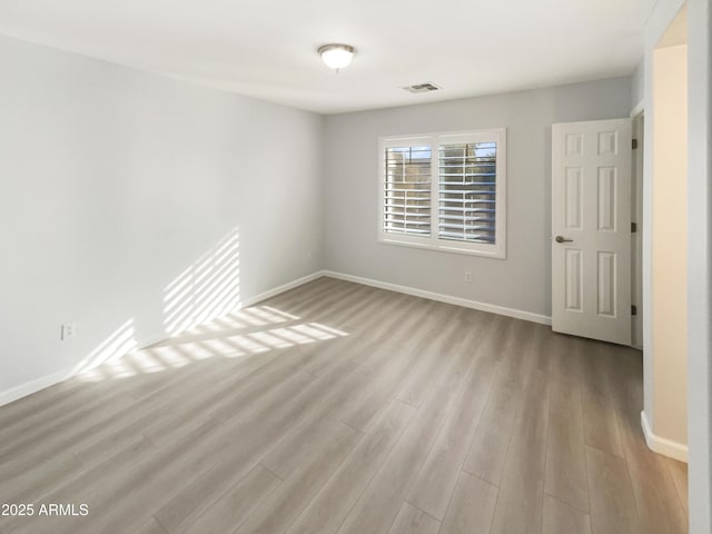 spare room with light wood-type flooring