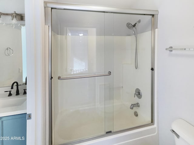 full bathroom featuring vanity, toilet, and combined bath / shower with glass door