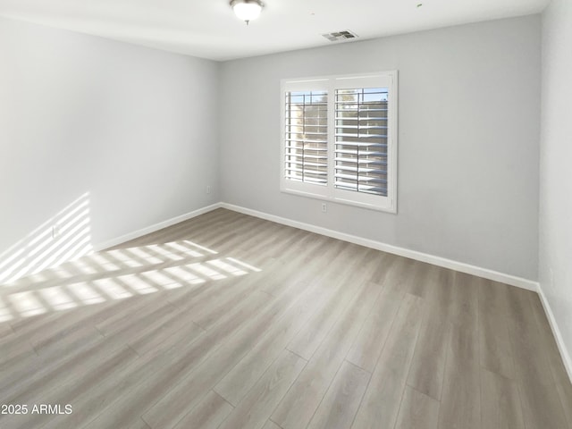 unfurnished room with light hardwood / wood-style flooring