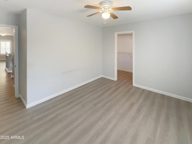 spare room featuring ceiling fan and light hardwood / wood-style floors